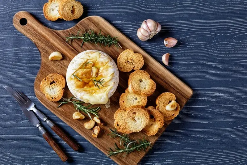 Spread of Baked Camembert with Garlic and Rosemary for Christmas starter ideas.