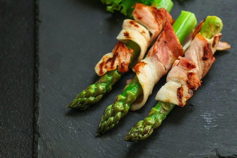 A plate of Prosciutto-Wrapped Asparagus for Christmas starters ideas.