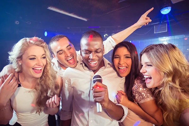 Friends enjoying karaoke, highlighting 21st birthday ideas for girls.