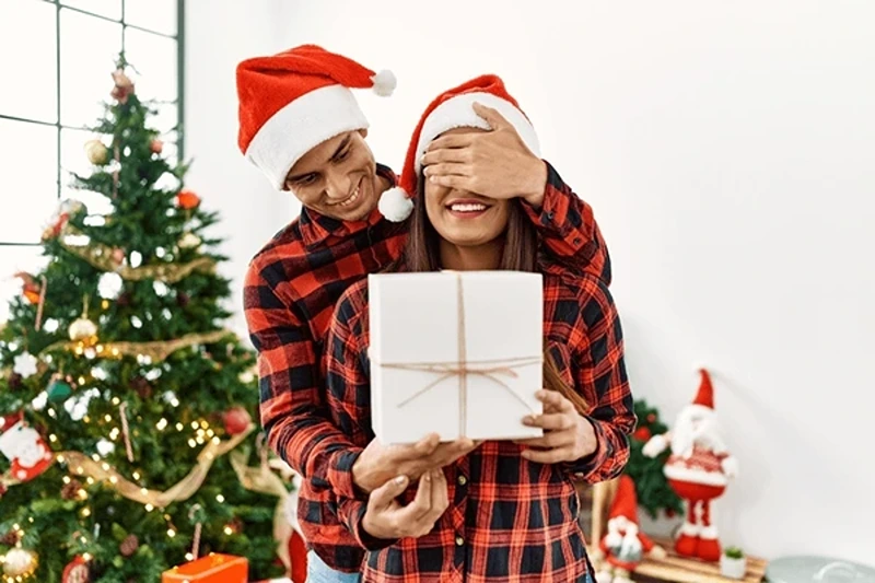 Man presenting a surprise Christmas present for wife UK.