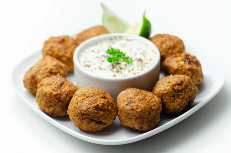 A plate of baked falafel bites for New Year's Eve meal ideas.