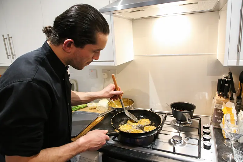 An Indian chef in Lanchester cooking a meal.