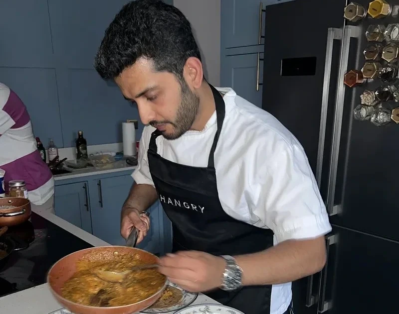 An Indian chef in Sheffield cooking a meal.