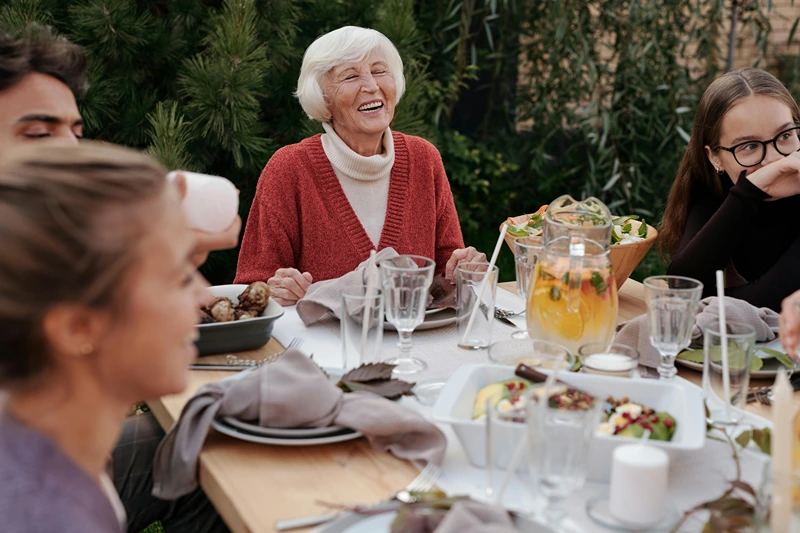 People enjoying a summer dinner party outdoors.