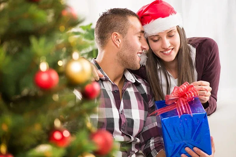 A couple shares a tender moment, inspiring ideas on what to buy a man for Christmas.