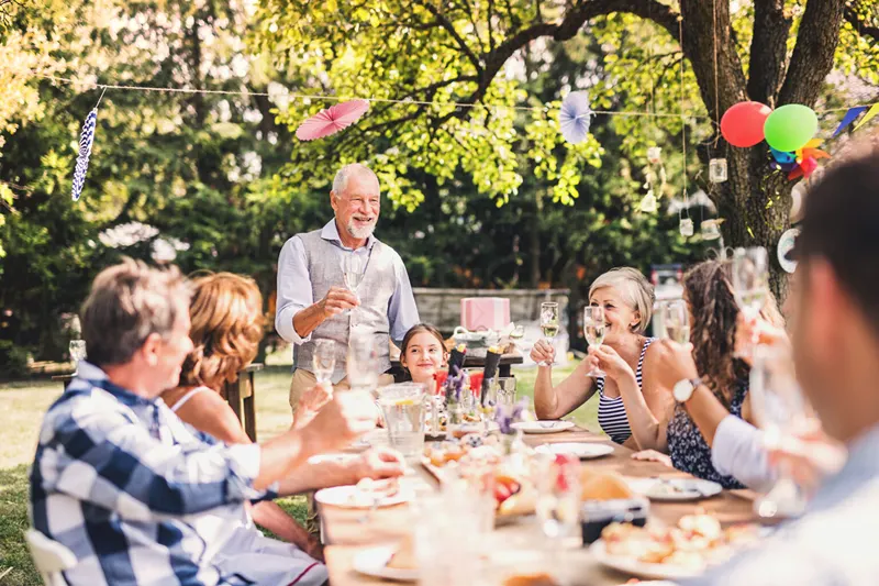 An older man enjoys a festive drink, sparking ideas on what to get men for Christmas.