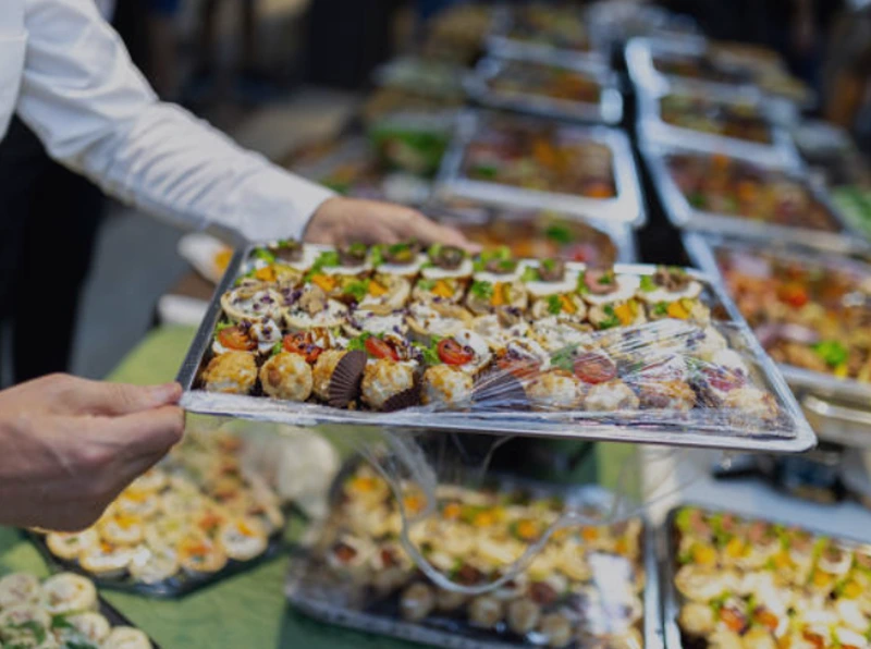 Chef showcasing dinner party canapes on a tray.