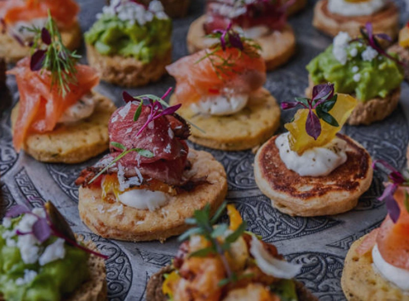 Deciding how many canapes per person from a beautiful spread.